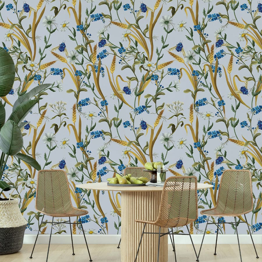 Elegant blue floral wallpaper in dining room; wooden table, wicker chairs, neutral flooring, indoor plant.