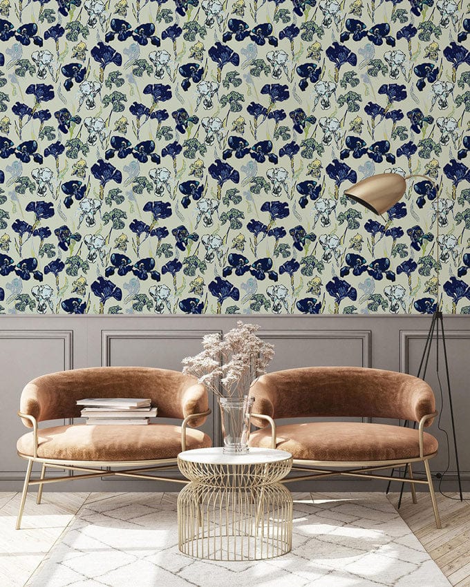 Elegant botanical wallpaper in muted blue and green with beige armchairs and gold floor lamp.