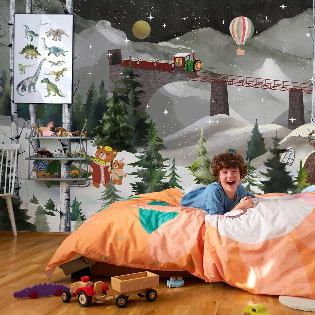 Children's room with 'Enchanting Winter Wonderland Mural' wallpaper, bear train scene, wooden flooring, playful decor.