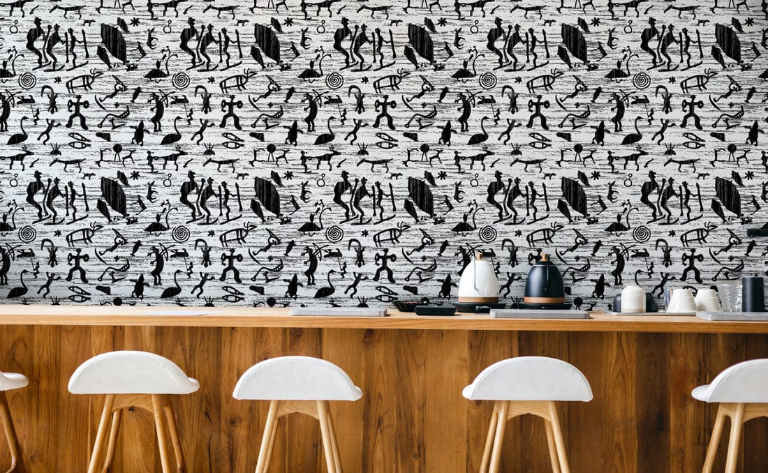 Monochrome tribal patterned wallpaper in retro style, wooden bar with white chairs, modern kitchen setting.