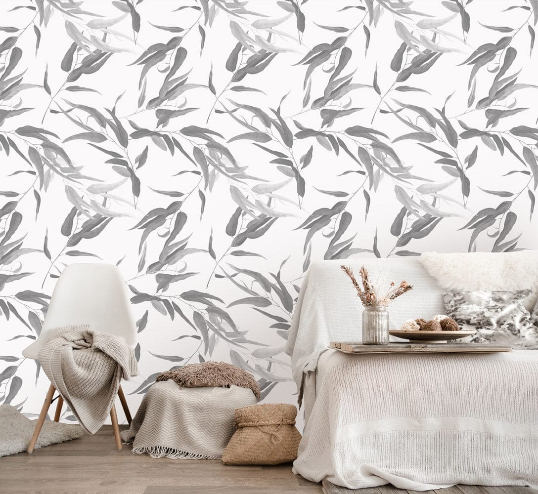 Modern minimalist grey leaf pattern wallpaper with cosy sofa, wooden flooring, and elegant room setting.