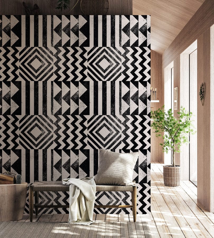 Bold monochrome geometric pattern wallpaper in modern hallway with wooden flooring and bench.