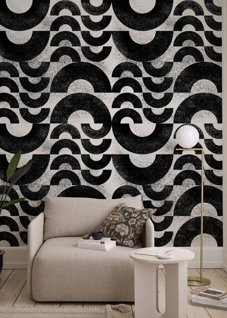 Monochrome vintage geometric wallpaper with beige sofa, wood flooring, and modern floor lamp in cosy room.