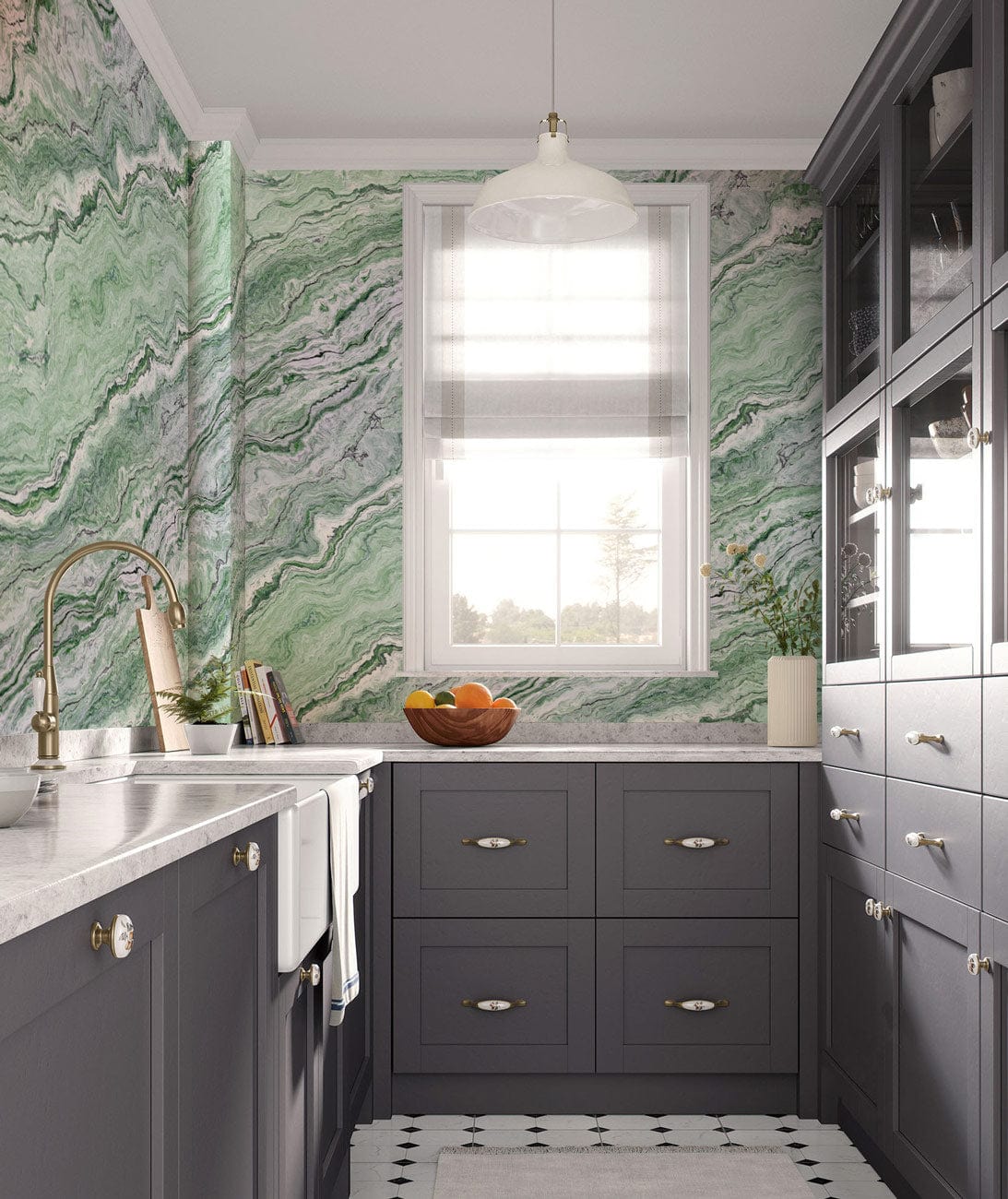 Elegant green marble wallpaper in modern kitchen, grey cabinets, white countertops, pendant light.