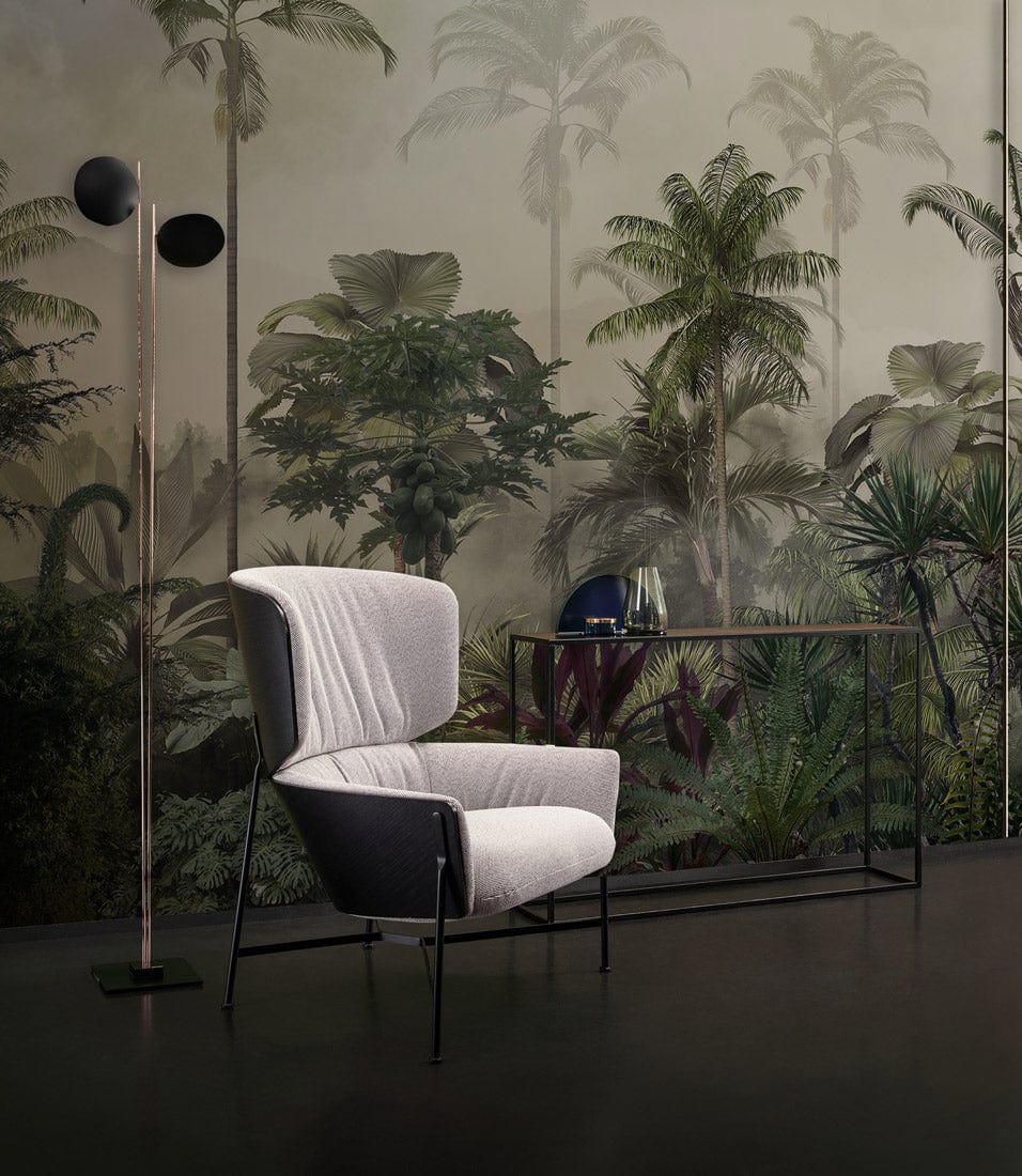Exotic Tropical Jungle Mural Wallpaper in living room with grey armchair, modern lamp, glass table.