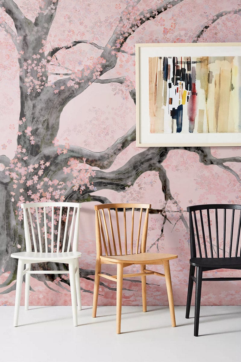 Elegant Cherry Blossom wall mural in soft pink watercolour style, featuring three chairs and abstract art.