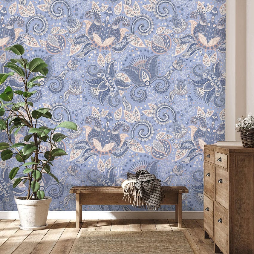 Elegant blue floral paisley wallpaper, wooden chest, potted plant, and hardwood floor in living room.