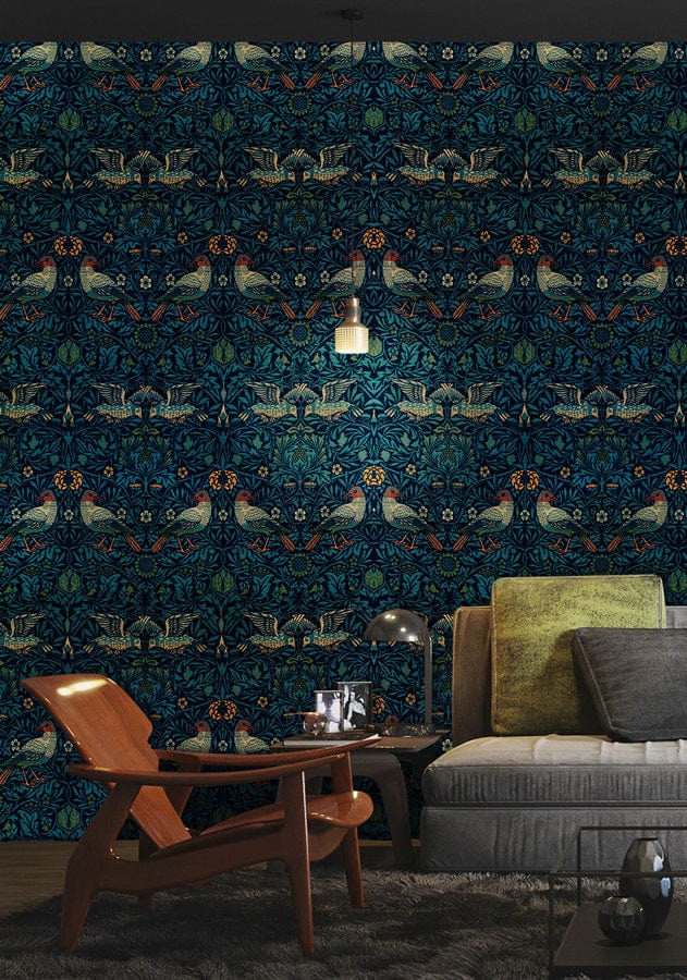 Luxurious Art Nouveau sapphire floral wallpaper, featuring grey sofa and warm-toned wooden armchair.