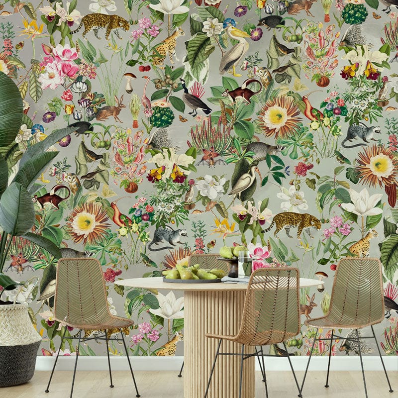 Exotic Jungle Floral Safari Mural Wallpaper in dining room with green plant, white table, wicker chairs.