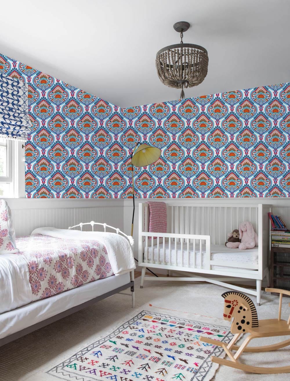 Elegant Blue and Orange Vintage Paisley Wallpaper in nursery with white cot, bed, and neutral carpet.