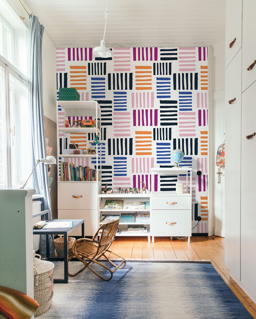Vibrant Geometric Stripe Wallpaper in a children's bedroom, with light wood flooring and white furniture.