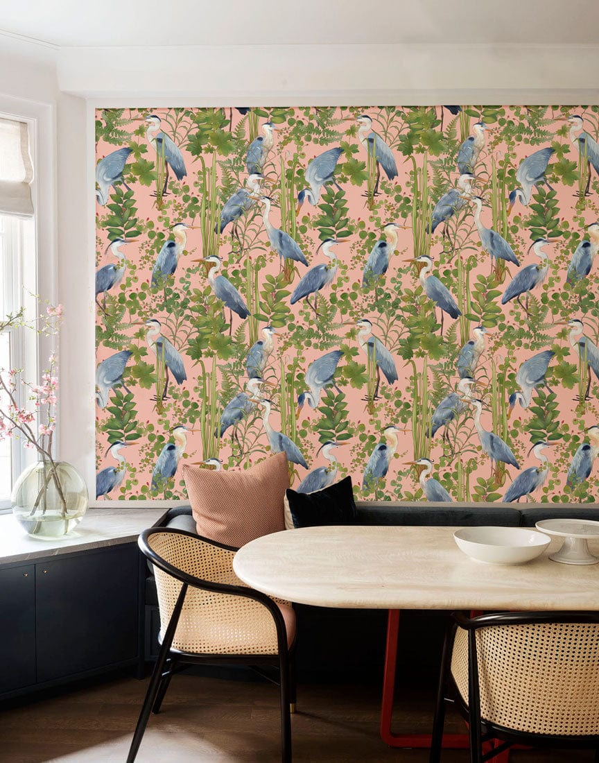 Exotic Blue Heron mural in dining room with cane chairs, wooden table, and modern decor elements.