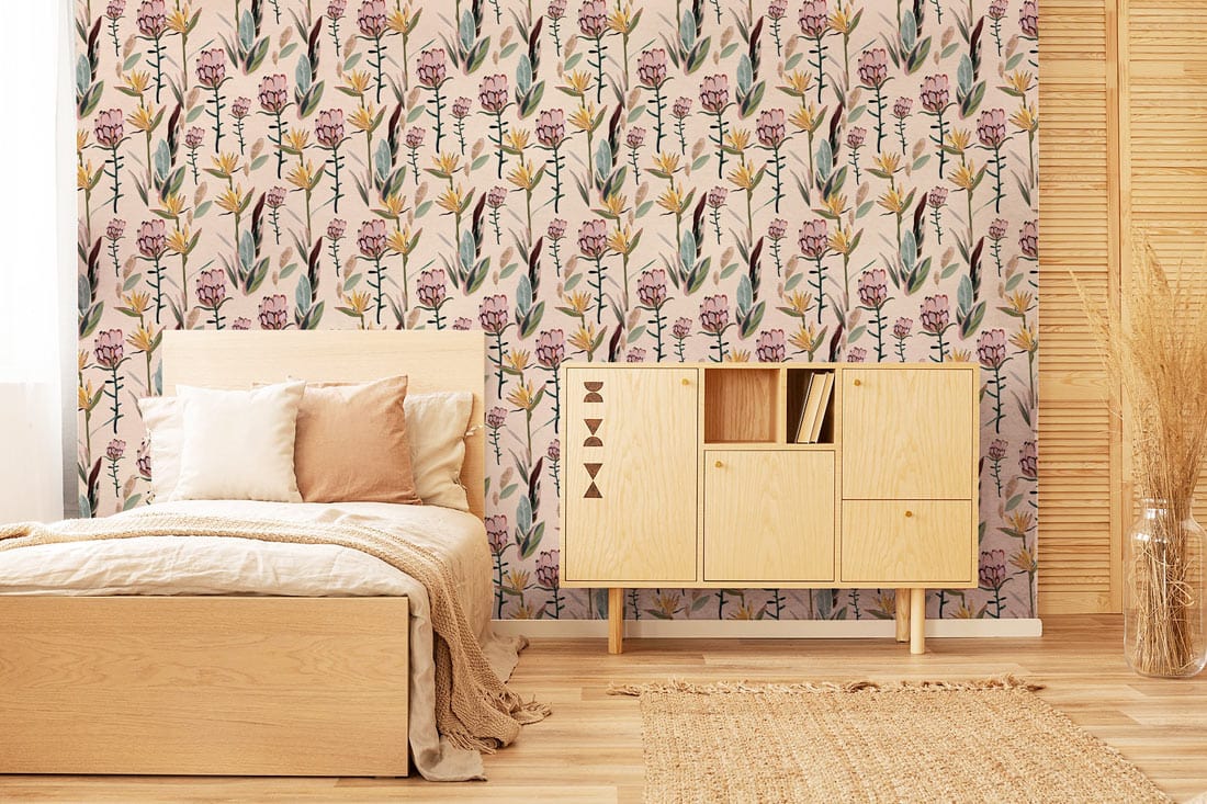 Vintage floral wallpaper with pink blossoms, wooden bed, beige rug, in cosy bedroom setting.