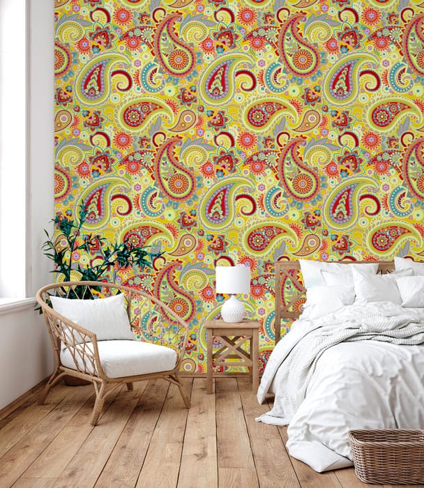 Vibrant Multicoloured Paisley Pattern Wallpaper, Bohemian yellow design with wicker chair, cosy bedroom.