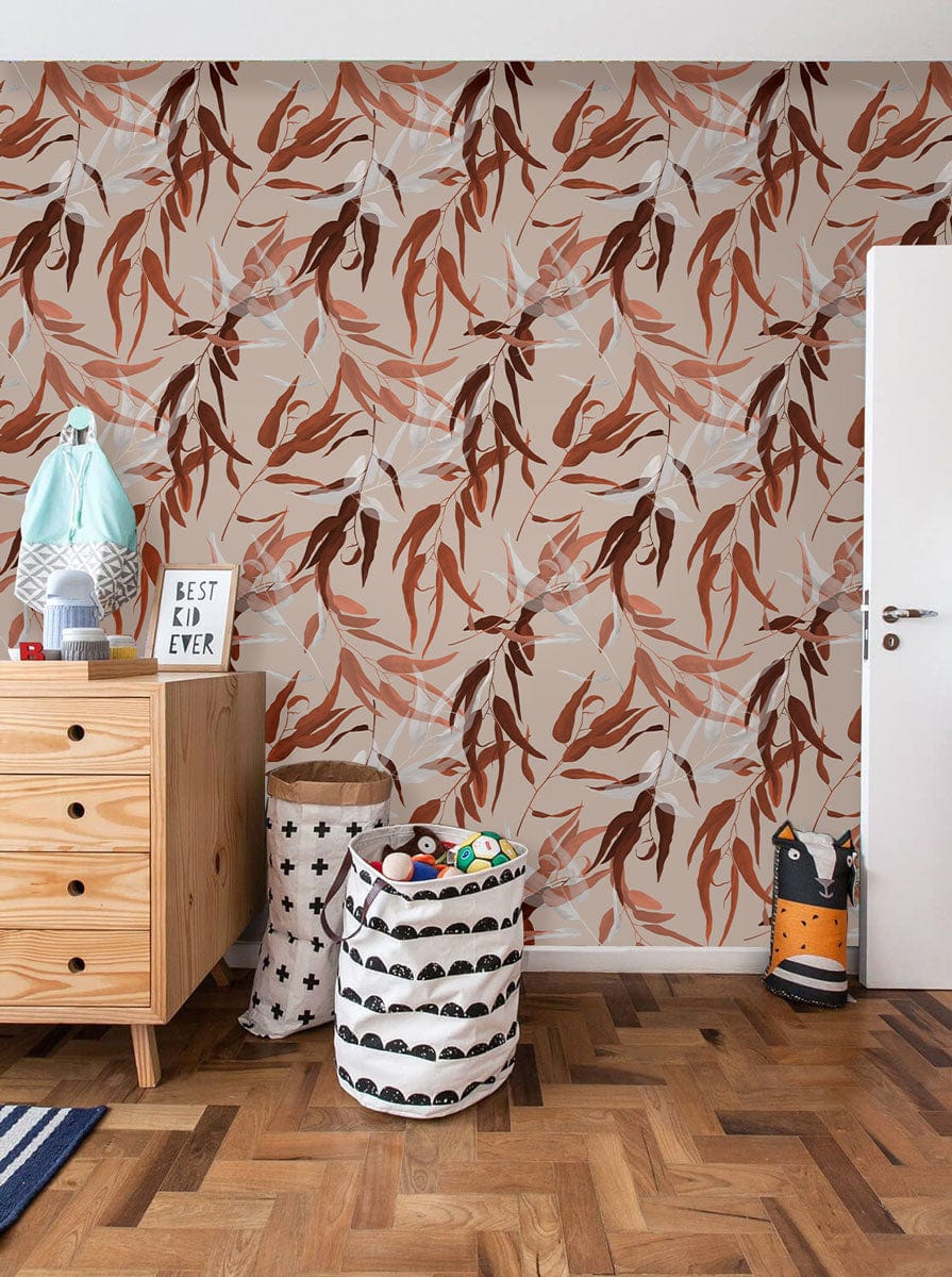 Elegant autumnal foliage wallpaper; earthy brown, beige hues; medium wood dresser; parquet flooring; children's room.