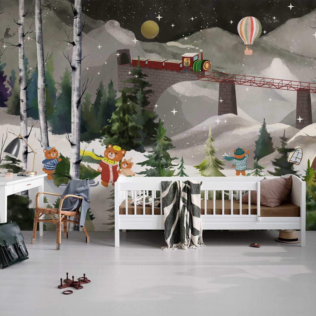 Children's room with Enchanting Winter Wonderland Mural featuring bears, train scene, white bed, and chair.