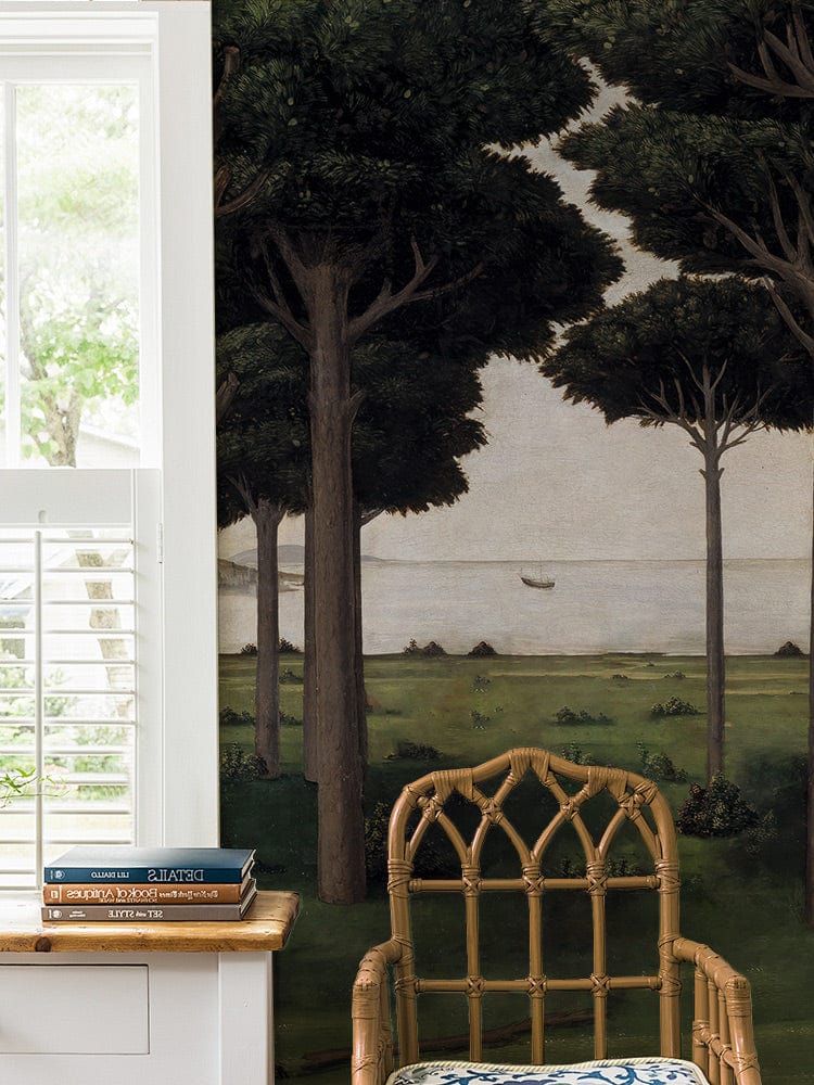 Enchanted Forest Mural Wallpaper in living room, bamboo chair, white panelled wall, hardwood floor.