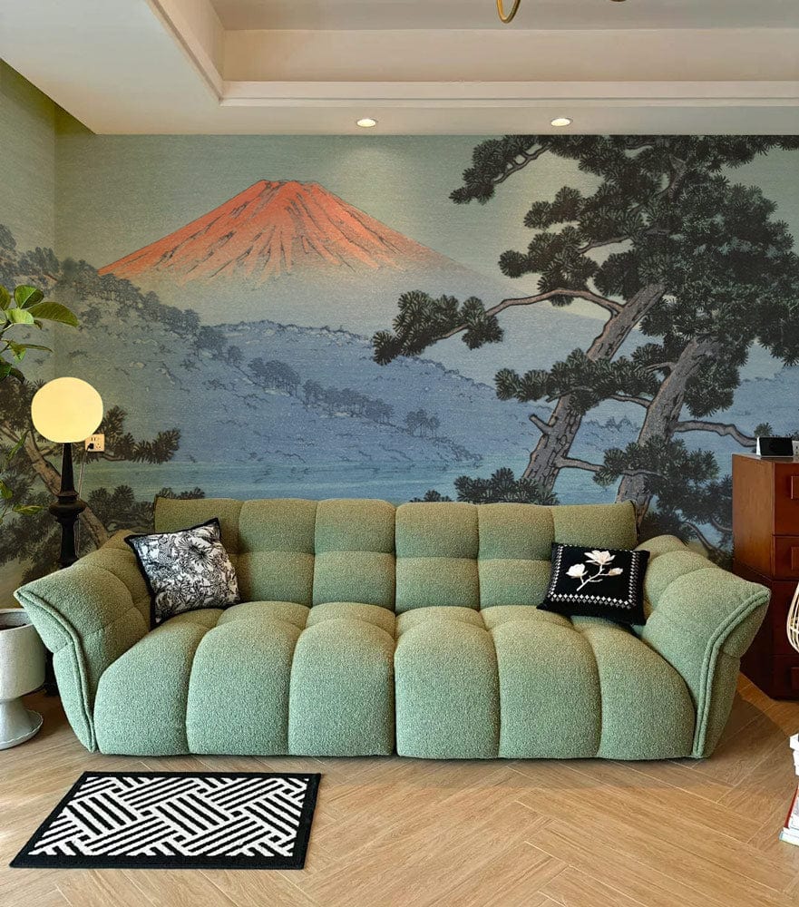 Watercolour Japanese-style mountain wallpaper in living room, green sofa, herringbone flooring, contemporary decor.