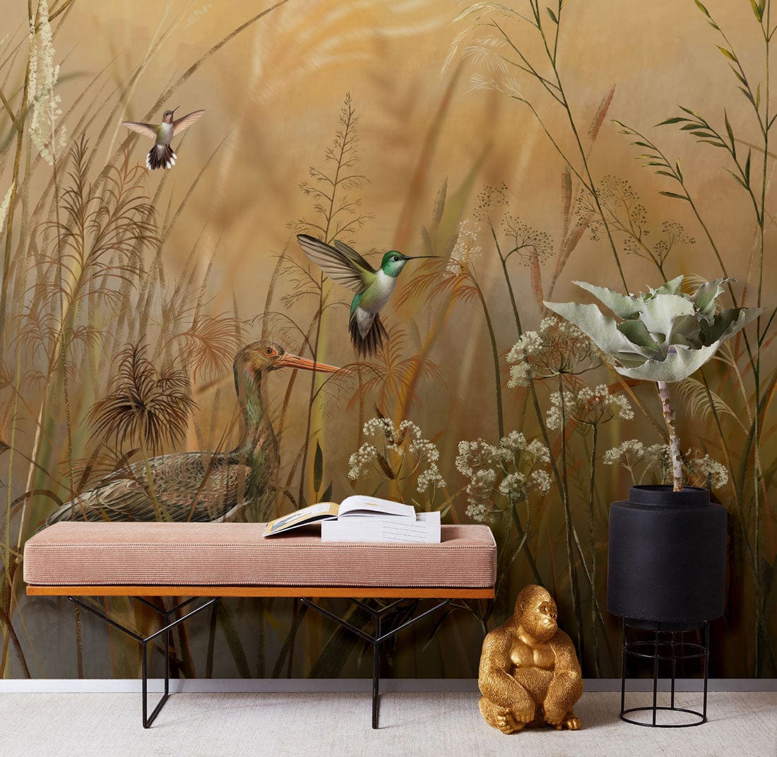 Vintage mural wallpaper with birds, warm earth tones; pink bench, black vase in living room.