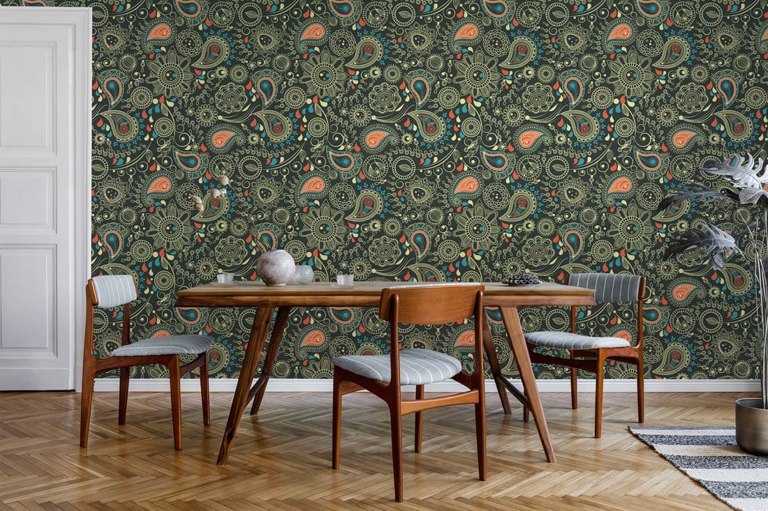 Elegant vintage paisley wallpaper with green and peach pattern, paired with mid-century dining furniture.