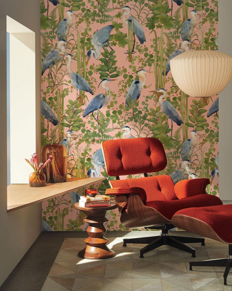 Exotic blue heron botanical mural, red chair, geometric flooring, pendant lamp in modern room setting.
