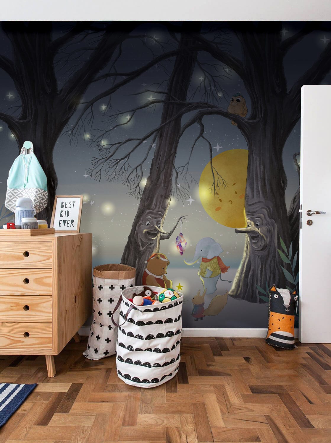 Children's bedroom with Enchanted Woodland Creatures mural, wooden dresser, parquet flooring, playful wall decor.