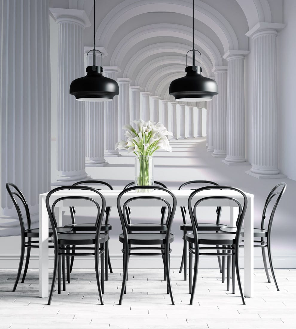Classic archway columns mural in dining room with black chairs, white table, and pendant lights.