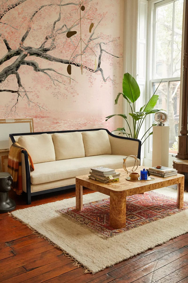 Elegant Cherry Blossom Mural Wallpaper in living room with cream sofa, wooden table, and parquet floor.