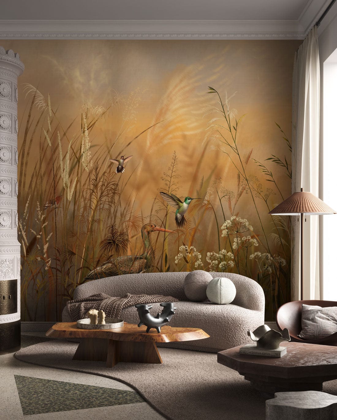 Vintage Autumn Meadow Mural Wallpaper with birds, curved grey sofa, wooden table, beige carpet, cosy room.