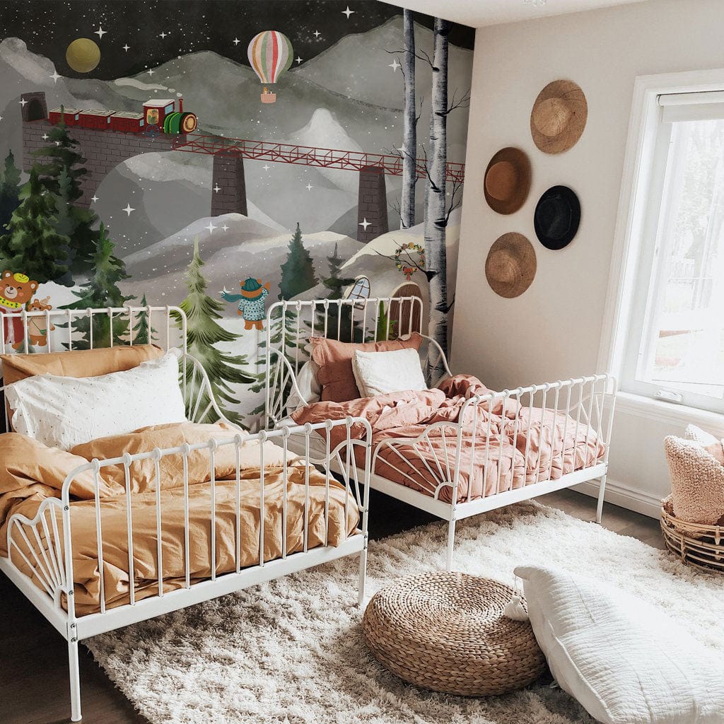 Enchanting Winter Wonderland mural with bears, train; white beds, cosy nursery decor, wooden flooring.