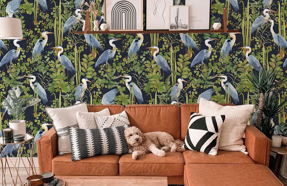 Elegant Blue Heron wallpaper in lush greenery; brown sofa, patterned cushions, modern decor, contemporary living room.