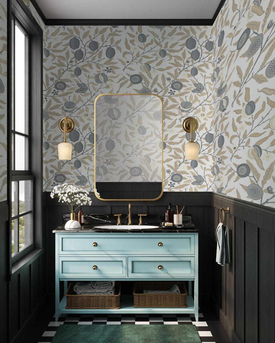 Elegant grey and beige floral wallpaper in bathroom with blue vanity and gold mirror accents.