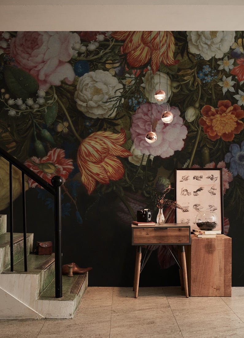 Exquisite dark floral mural wallpaper with rich multicolour blooms, staircase, wooden console, and beige tiles.