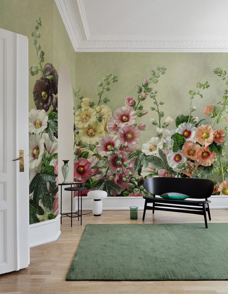 Elegant floral mural wallpaper with black sofa, green rug, wooden flooring in a vintage living room.