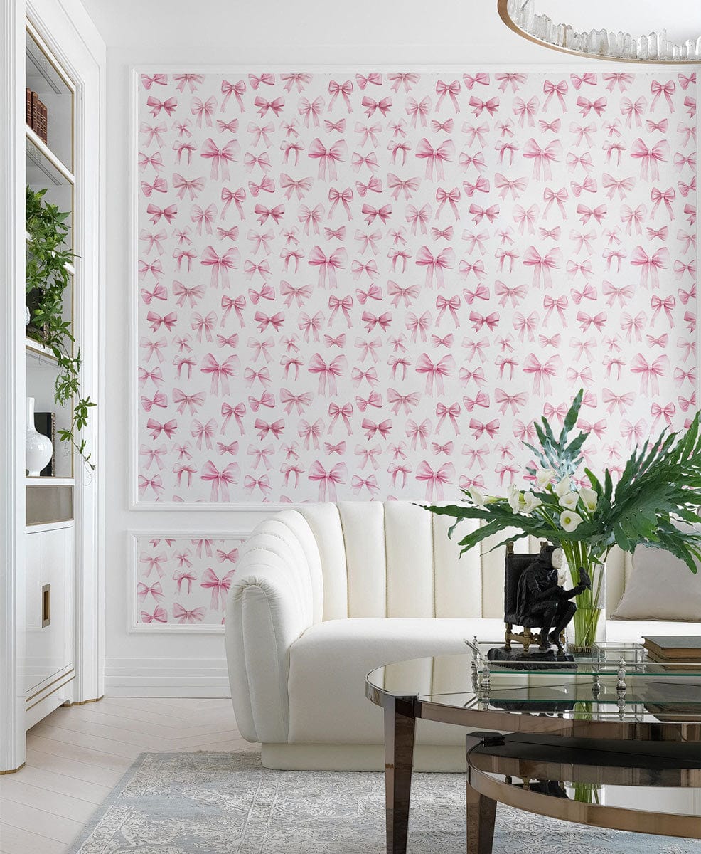 Charming Pink Bow Pattern Wallpaper in elegant nursery with white sofa and glass coffee table.