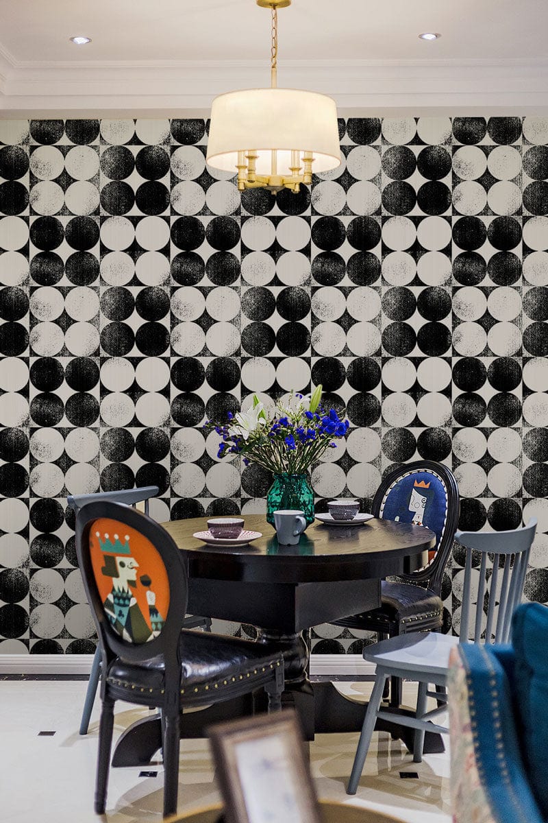 Dining room with Monochrome Geometric Op Art Circles Wallpaper, eclectic chairs, round table, pendant light.