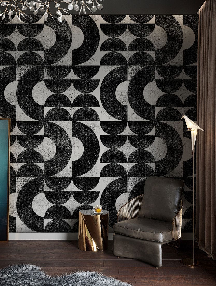 Retro geometric black and white abstract wallpaper in modern living room with leather chair, wood flooring.