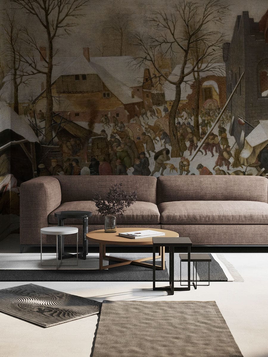 Brown sofa in rustic room with Vintage Winter Village Scene Mural Wallpaper, beige rug, grey flooring.