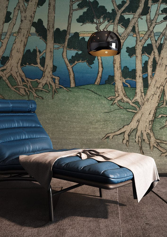 Tranquil Coastal Forest Scene Blue Green Mural with blue lounge chair, grey flooring, hanging lamp.
