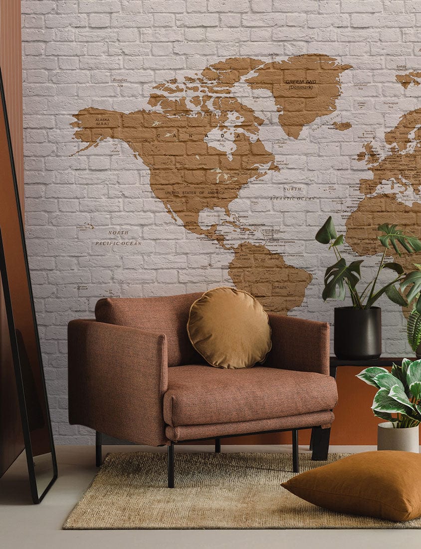 Vintage Brick World Map Mural Wallpaper with brown armchair, rustic rug, modern home decor.