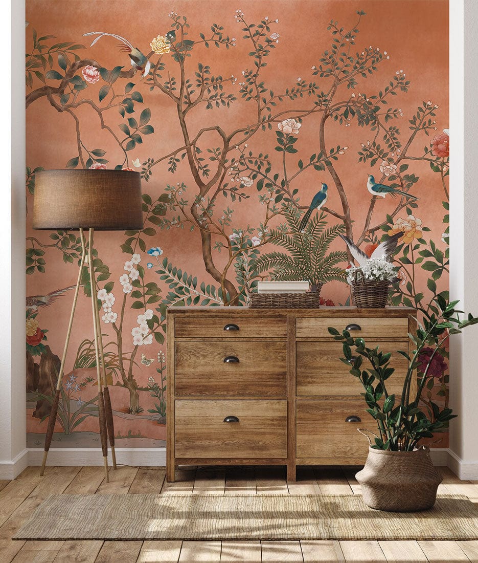 Chinoiserie Coral Garden Mural Wallpaper with exotic birds, wooden chest, natural flooring in living room.