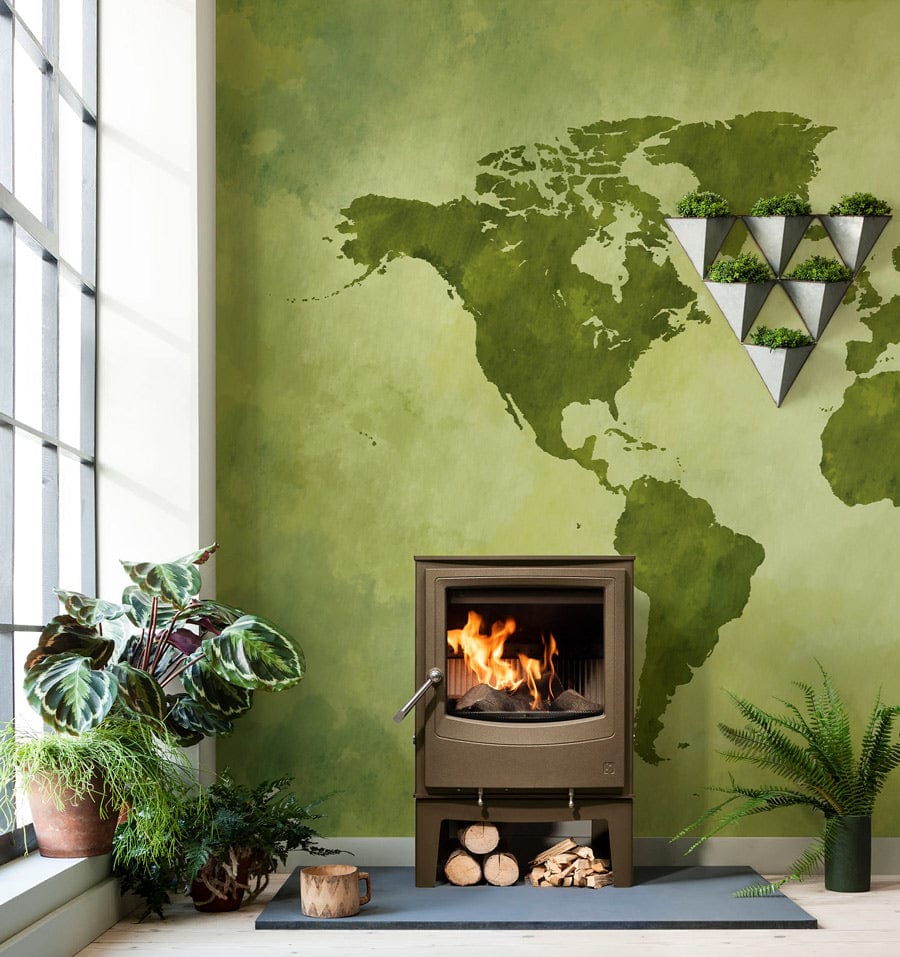 Vintage green world map mural wallpaper with burning stove, geometric shelf, and earthy living room decor.