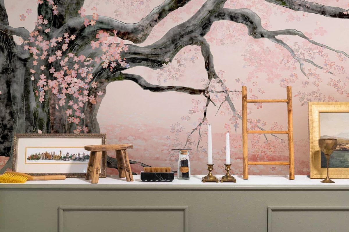 Elegant Cherry Blossom Mural Wallpaper, soft pink Japanese style; green wainscoting, decorative ladder, framed art.