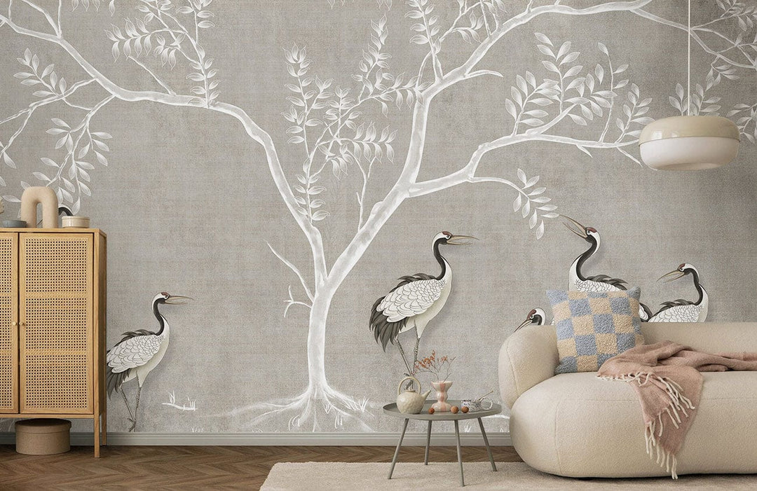 Elegant grey crane and tree mural wallpaper decor in living room with beige sofa and wooden cabinet.