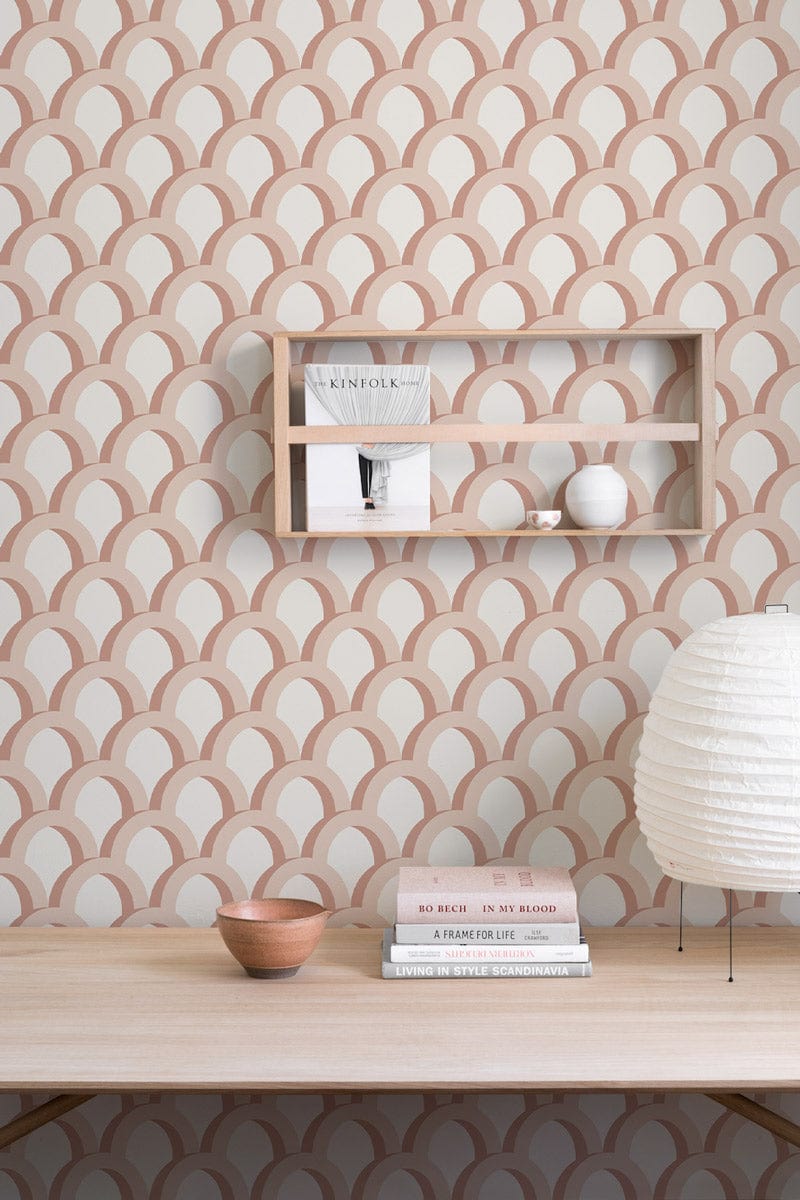 Elegant peach scales wallpaper with minimalist design, light wooden shelving, and desk lamp in modern room.