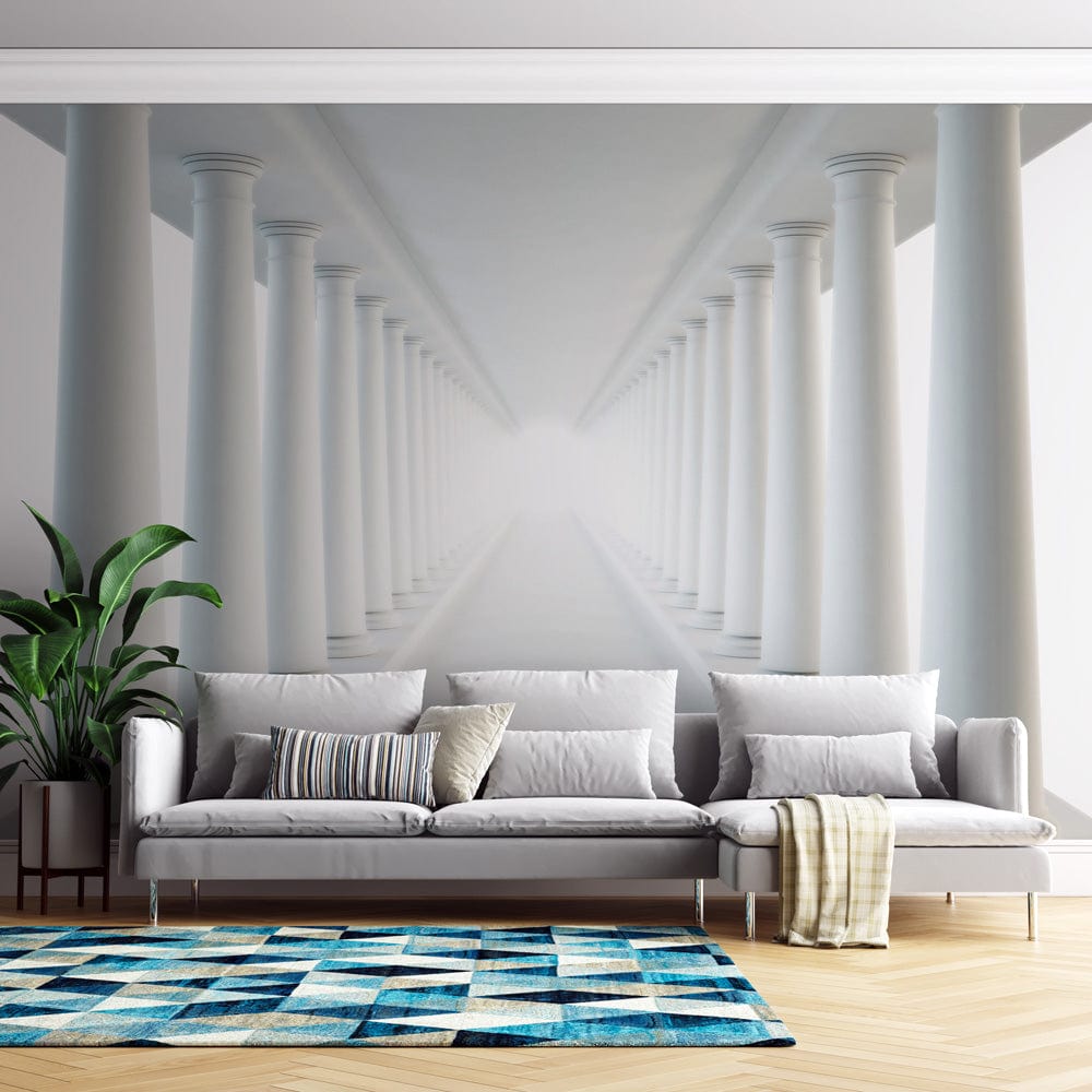 Sophisticated interior with Elegant White Pillars Illusion Mural Wallpaper, grey sofa, geometric blue rug.