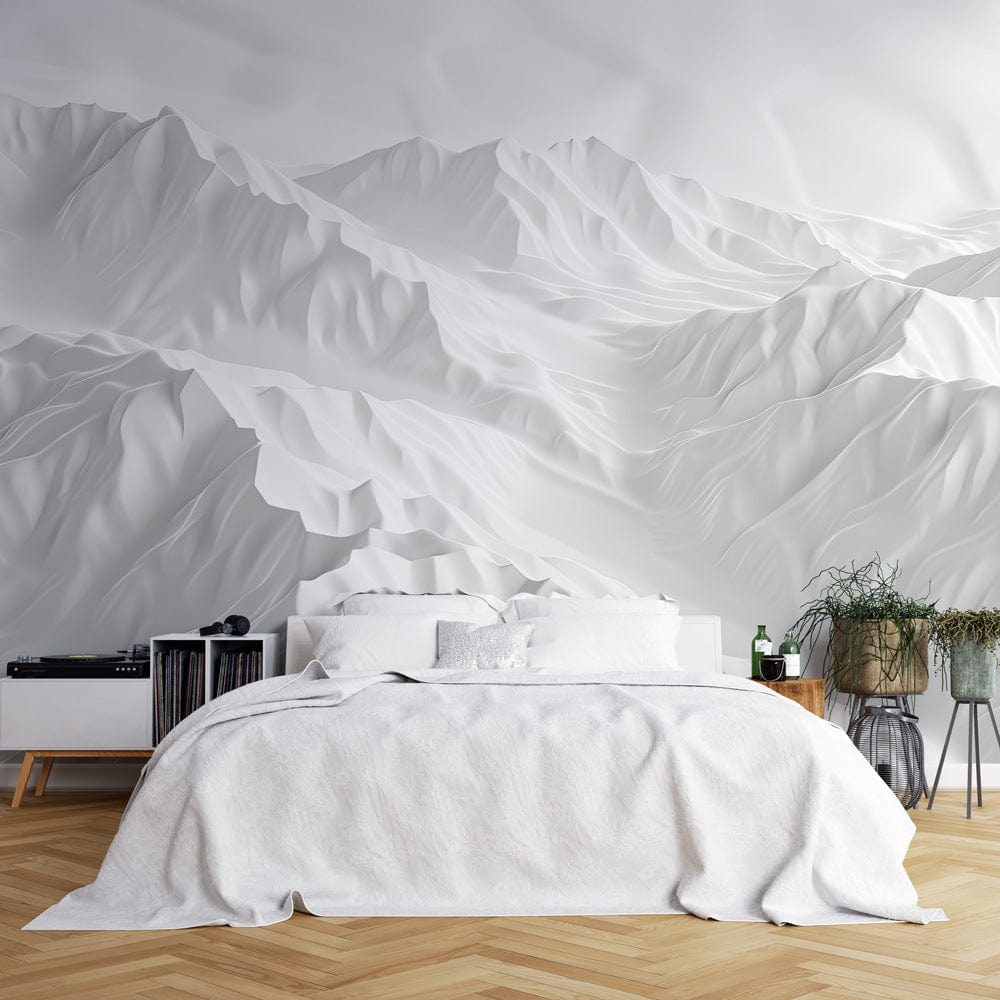 Elegant white 3D mountain landscape wallpaper in modern bedroom with parquet flooring behind white bed.