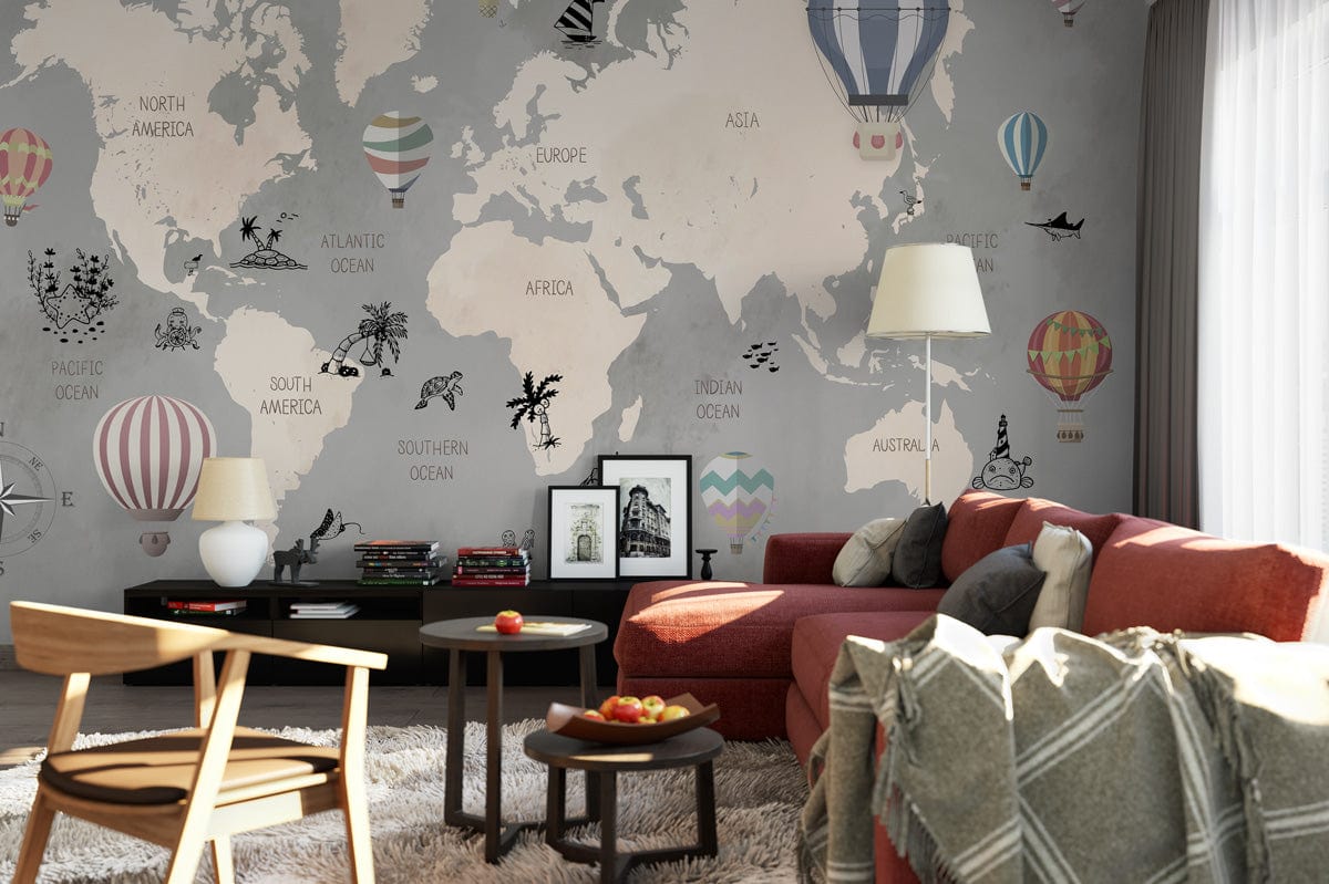 Vintage world map mural wallpaper with pastel balloons in cosy living room, red sofa, light rug.