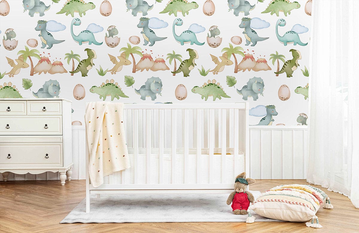 Playful pastel dinosaur mural wallpaper in nursery; white crib, vintage dresser, light wood flooring.