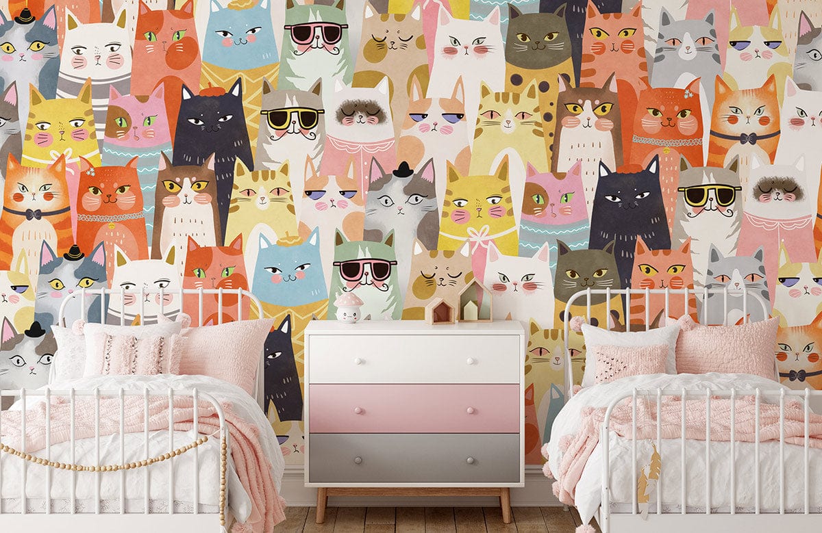 Colourful whimsical cats wallpaper in children's room with twin white beds, pastel dresser, wooden flooring.
